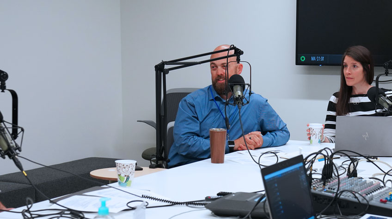Four people recording a podcast
