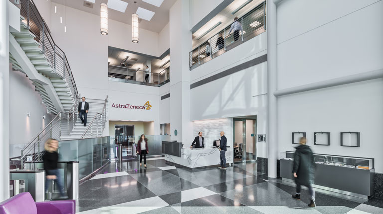 Interior view of decorative flooring and busy lobby at AstraZeneca