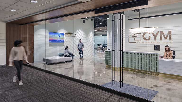 Large glass doors show entrance to The Gym.