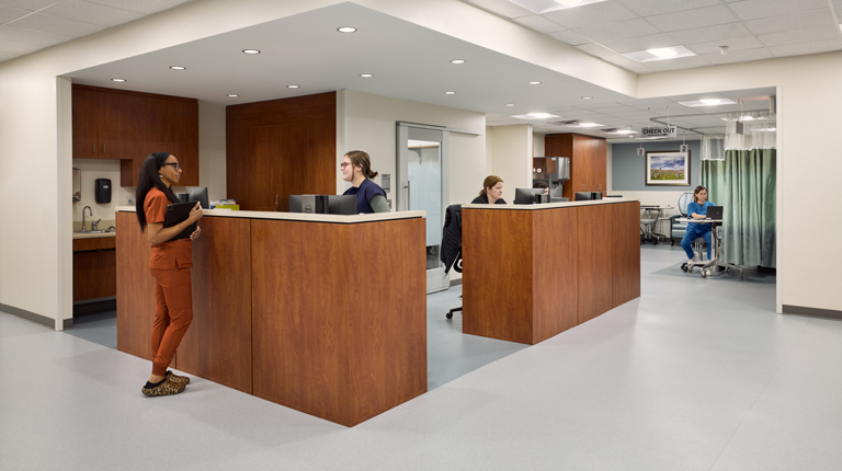 Healthcare providers talk at the central care team area