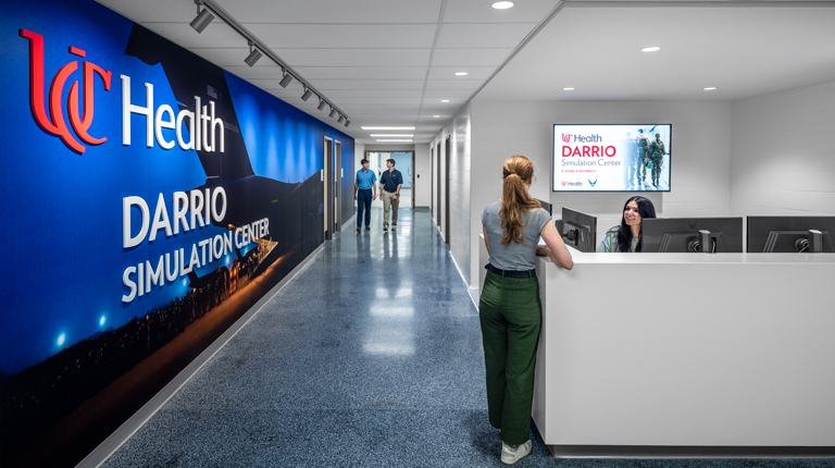People chatting at the UC Health DARRIO Sim Center Front Desk