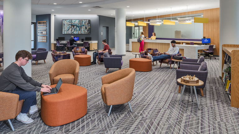 Students sit inside a new study area at Archer Library