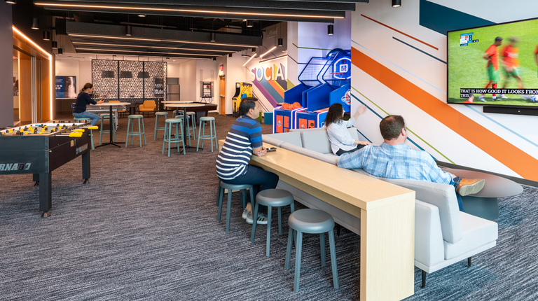 Employees watch tv in the new Social Hub