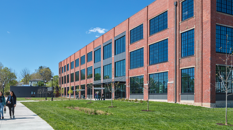 A couple of students walk in front of the new OU Russ Research Opportunity Center building