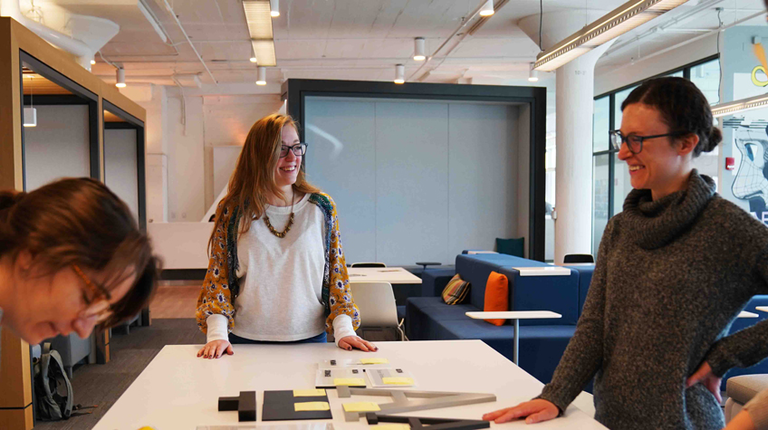 Graphic designers work together on a sample review